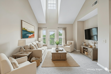 Newnan apartment for rent - A living room with a large painting on the wall and a flat screen TV mounted above the entertainment center.