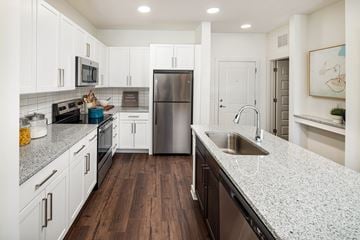 Locust Grove apartment for rent - A modern kitchen with white cabinets and a stainless steel refrigerator.