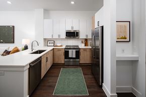 Atlanta apartment for rent - a kitchen with white cabinets and stainless steel appliances