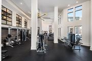 Atlanta apartment for rent - A gym with a variety of equipment and a large mirror on the wall.