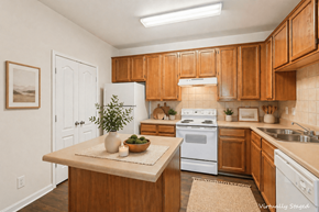 Stonecrest apartment for rent - A kitchen with wooden cabinets and a white fridge.
