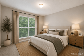 Stonecrest apartment for rent - A bedroom with a large bed, a nightstand, and a window with a view of trees.