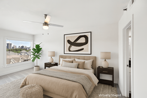 Atlanta apartment for rent - A bedroom with a large bed, a ceiling fan, and a large abstract painting above the bed.