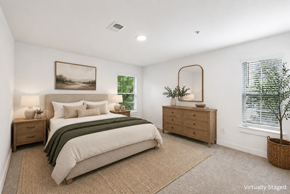 Lawrenceville apartment for rent - A bedroom with a bed, nightstands, and a plant.