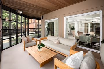 Atlanta apartment for rent - A modern living room with a wooden coffee table and a glass wall.