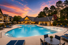 Lithia Springs apartment for rent - A large outdoor swimming pool surrounded by lounge chairs and a table with a potted plant.