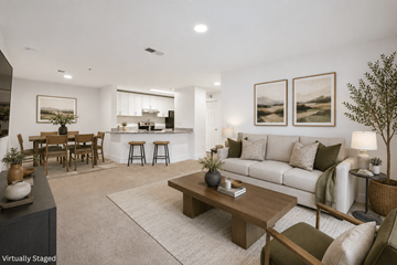 Lithia Springs apartment for rent - A modern living room with a white couch, wooden coffee table, and a dining table with chairs.