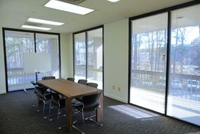 Atlanta apartment for rent - A conference room with a long table and chairs.