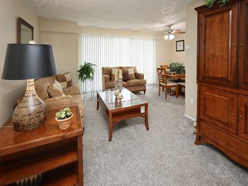 Willoughby Hills apartment for rent - A living room with a wooden coffee table and a lamp.