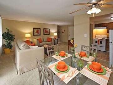 Euclid apartment for rent - A living room with a glass dining table set for four.