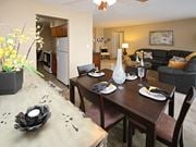 Euclid apartment for rent - Dining room with table settings and living area at Harbor Crest Apartments, Euclid