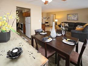 Euclid apartment for rent - Dining room with table settings and living area at Harbor Crest Apartments, Euclid