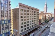 Cleveland apartment for rent - A city street with a large building in the middle and a tall building in the background.