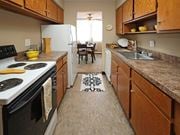Euclid apartment for rent - Galley kitchen with electric stove and brown countertops at Harbor Crest Apartments, Ohio, 44123