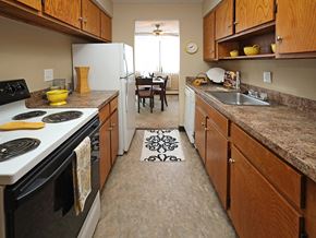 Euclid apartment for rent - Galley kitchen with electric stove and brown countertops at Harbor Crest Apartments, Ohio, 44123