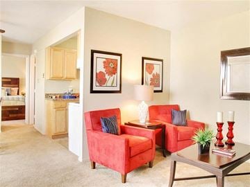Euclid apartment for rent - a living room with two red chairs and a table