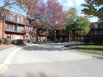 Twinsburg apartment for rent - Apartment complex with a tree with red leaves.