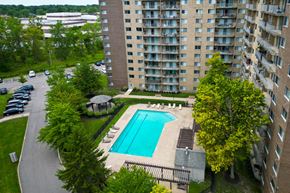 Willoughby Hills apartment for rent - outdoor swimming pool and sundeck surrounded by trees at Willoughby Hills Towers Apartments, Willoughby Hills, OH 44092