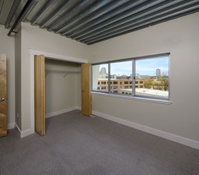 Grand Rapids townhouse for rent - A room with a large window and a view of buildings outside.