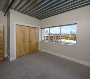Grand Rapids townhouse for rent - A room with a window overlooking a cityscape.