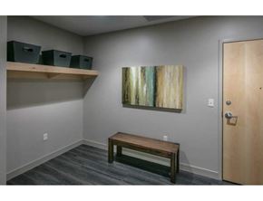 Grand Rapids apartment for rent - A room with a wooden bench, a painting on the wall, and a door.