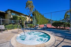 Vista apartment for rent - A hot tub sits in the middle of a patio surrounded by a fence.