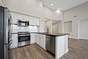 Westminster apartment for rent - a kitchen with stainless steel appliances and white cabinets