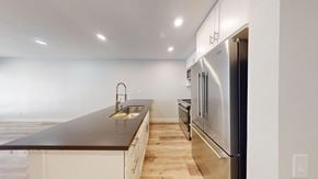 Thousand Oaks apartment for rent - a kitchen with white cabinets and a stainless steel refrigerator at Charter Oaks Apartments, California, 91360
