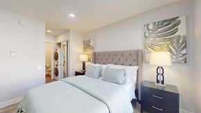 Thousand Oaks apartment for rent - a bedroom with a large white bed and a painting on the wall at Charter Oaks Apartments, California