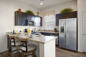 Chandler apartment for rent - A kitchen with a table and chairs and a refrigerator.
