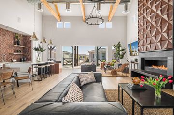 Phoenix apartment for rent - A modern living room with a black leather sofa and a fireplace.