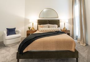 Durham apartment for rent - a bedroom with a bed and a chair and a window