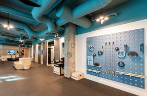 Raleigh apartment for rent - a room with a large blue wall with tools on it