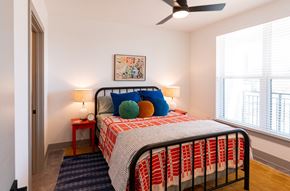 Raleigh apartment for rent - a bedroom with a bed and two windows and a ceiling fan