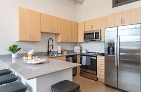 Greensboro apartment for rent - a kitchen with stainless steel appliances and an island with a counter top