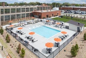 Greensboro apartment for rent - an aerial view of an outdoor pool at a hotel with umbrellas