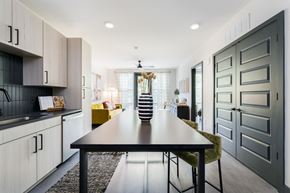 Raleigh apartment for rent - a dining area with a black dining table and yellow chairs