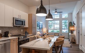 Raleigh apartment for rent - A kitchen with a dining table and chairs.