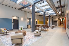 Greensboro apartment for rent - the lobby of a large building with seating and tables