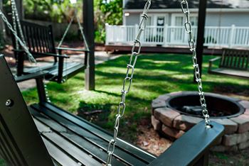 Courtyard with fire pit and wooden porch swings