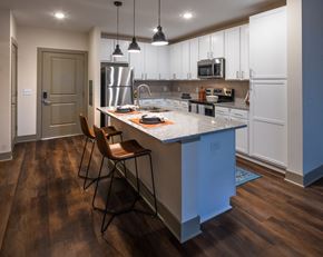 Pittsboro apartment for rent - a kitchen with white cabinets and a blue island