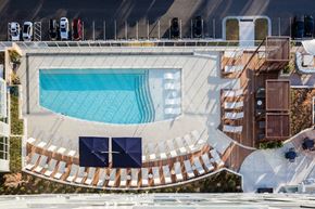 Raleigh apartment for rent - A swimming pool with a sun lounger and a white wall.