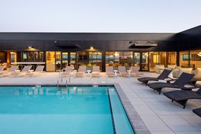 Durham apartment for rent - a pool with lounge chairs and a building in the background