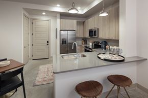 Durham apartment for rent - a kitchen with a large island with two stools