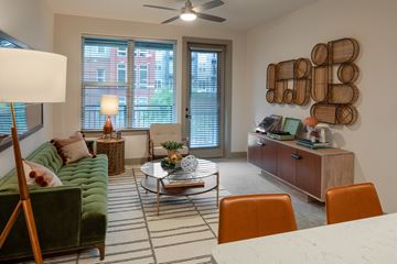 Durham apartment for rent - a living room with a green couch and chairs and a coffee table