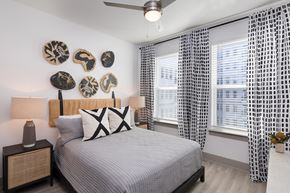 Raleigh apartment for rent - a bedroom with a bed and two windows