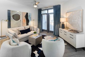 Raleigh apartment for rent - a living room with a white couch and two chairs