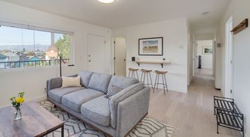 Oakland apartment for rent - A living room with a grey couch and a coffee table.