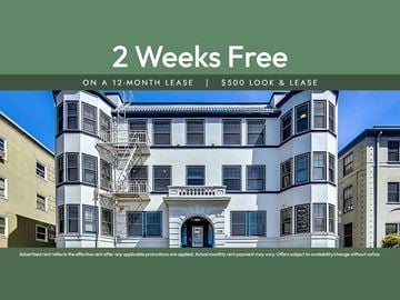 Oakland apartment for rent - A building with a sign offering a 2 weeks free on a 12-month lease.