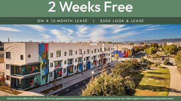 Oakland apartment for rent - A building complex advertises a 2 weeks free offer on a 12-month lease.